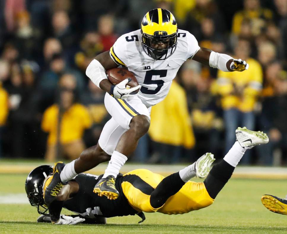 FILE - In this Nov. 12, 2016, file photo, Michigan's Jabrill Peppers (5) breaks a tackle by Iowa defensive back Desmond King, rear, during the first half of an NCAA college football game, in Iowa City, Iowa. With safeties such as LSU's Jamal Davis and Ohio State's Malik Hooker available, the former Michigan star and Heisman Trophy finalist might slip out of the first round of the NFL Draft. (AP Photo/Charlie Neibergall, File)