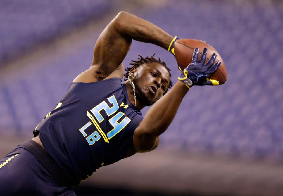 FILE - In this March 6, 2017, file photo, linebacker Jabrill Peppers makes a catch as he runs a drill at the NFL football scouting combine in Indianapolis. With safeties such as LSU's Jamal Davis and Ohio State's Malik Hooker available, the former Michigan star and Heisman Trophy finalist might slip out of the first round of the NFL Draft. (AP Photo/Michael Conroy, File)