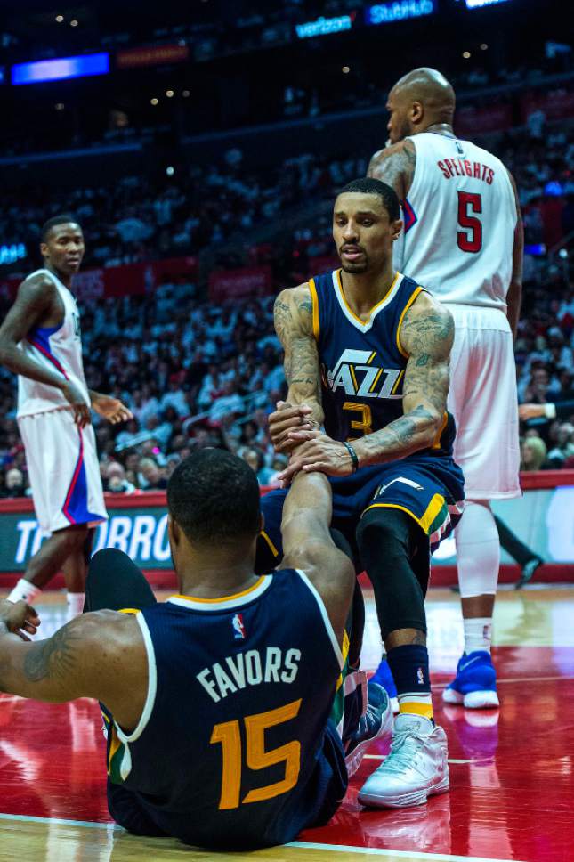 Chris Detrick  |  The Salt Lake Tribune
Utah Jazz guard George Hill (3) helps up Utah Jazz forward Derrick Favors (15) during Game 1 of the Western Conference at the Staples Center Saturday, April 15, 2017.  Utah Jazz defeated LA Clippers 97-95.