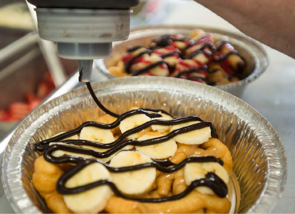 Rick Egan  |  The Salt Lake Tribune

The "Elvis Presley"  funnel cake is made in theThe Other Side Food Truck. The Truck is a part of the Other Side Academy, a non-profit that helps disadvantaged adults get their lives back on track through hard work and discipline, Thursday, April 6, 2017.