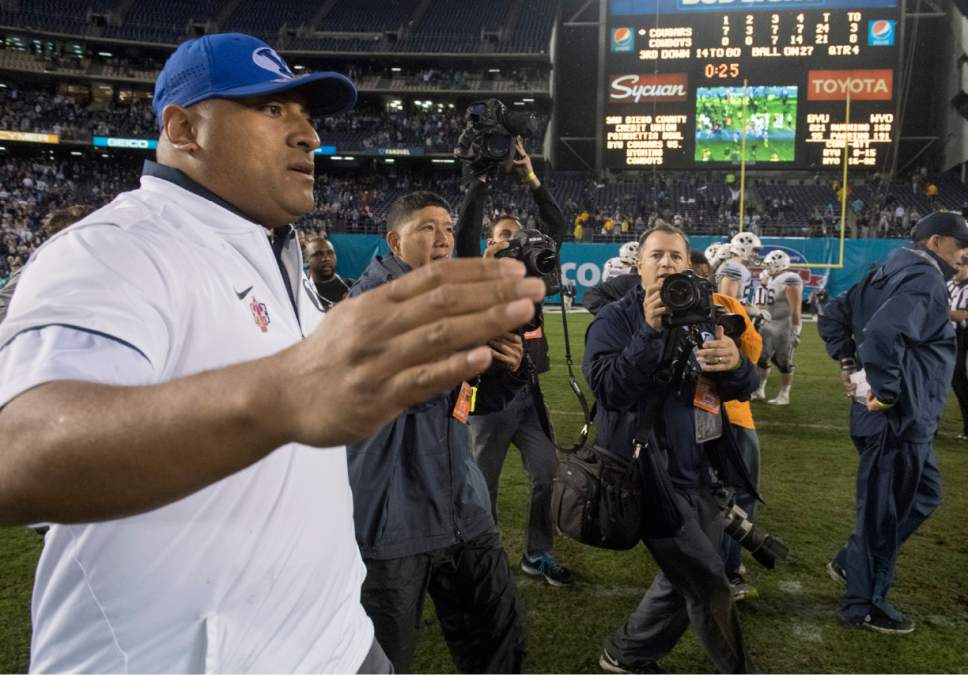 Rick Egan  |  The Salt Lake Tribune

Brigham Young Cougars head coach Kalani Sitake enters the field to shake hands with the Wyoming coach, after the Cougars defeated Wyoming 21-21, in the Poinsettia Bowl, at Qualcomm Stadium in San Diego, December 21, 2016.