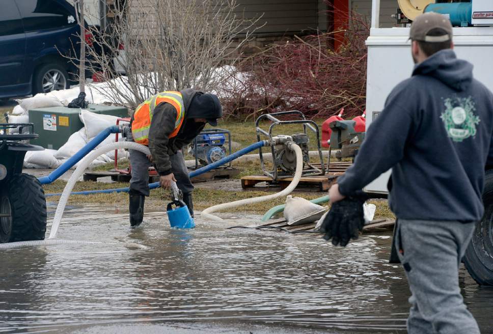 Al Hartmann  |  The Salt Lake Tribune
Residents man the pumps near 125 North 1650 West in Tremonton to pump standing water away from homes into the street Monday Feb. 20 before the next storm drops more rain.   Parts of Box Elder County have seen surface flooding from the rapid snow melt and rain over the weekend.  Luckily these homes do not have basements but water rose nearly to the front doors of some homes.  Main Street in Tremonton from 1000 to 2000 West was closed last night to pump out the area.