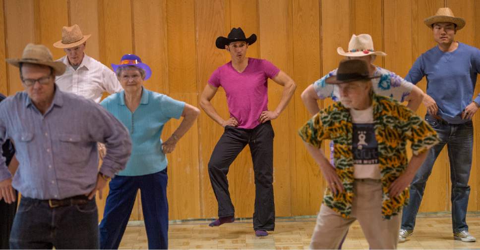 Leah Hogsten  |  The Salt Lake Tribune 
University of Utah dance professor, Juan Carlos Claudio, (center), leads a dress rehearsal Thursday, April 20, 2017, at the 10th East Senior Center for a Saturday, April 22 dance performance, "That 70's Show" by Grey Matters Dance for Parkinson's - Utah. The Grey Matters program is a way for participants to use dance and creativity to alleviate the physical, social, emotional and cognitive symptoms of the disease.