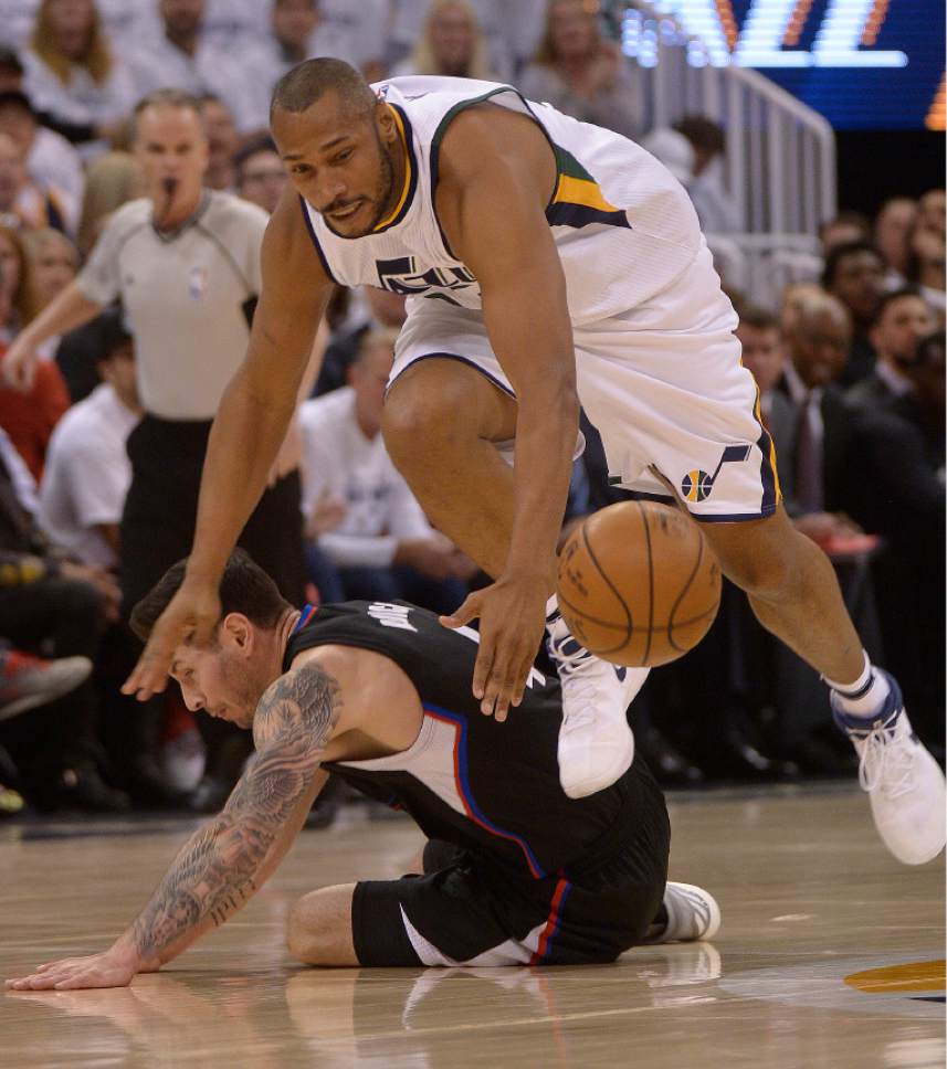 Leah Hogsten  |  The Salt Lake Tribune 
Utah Jazz center Boris Diaw (33) hits the deck trying to get to the ball before LA Clippers guard JJ Redick (4). The Utah Jazz lead the Los Angeles Clippers after the first quarter during Game 3 of their first-round Western Conference playoff series at Vivint Smart Home Arena, Friday, April 21, 2017.