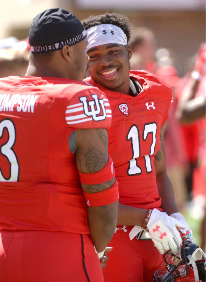 Leah Hogsten  |  The Salt Lake Tribune 
Linebacker Donavan Thompson shares a laugh with wide receiver Demari Simpkins. The University of Utah Utes were back in action  during the 16th-annual Red-White football game on Saturday, April 15, 2017 at  Rice-Eccles Stadium.