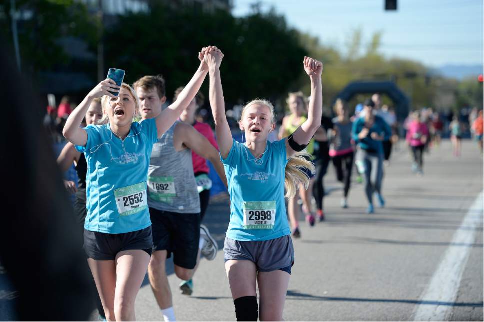 Scott Sommerdorf | The Salt Lake Tribune
Runners celebrate as they cross the finish line in the half-marathon part of the 2017 Salt Lake Marathon, Saturday, April 22, 2017.