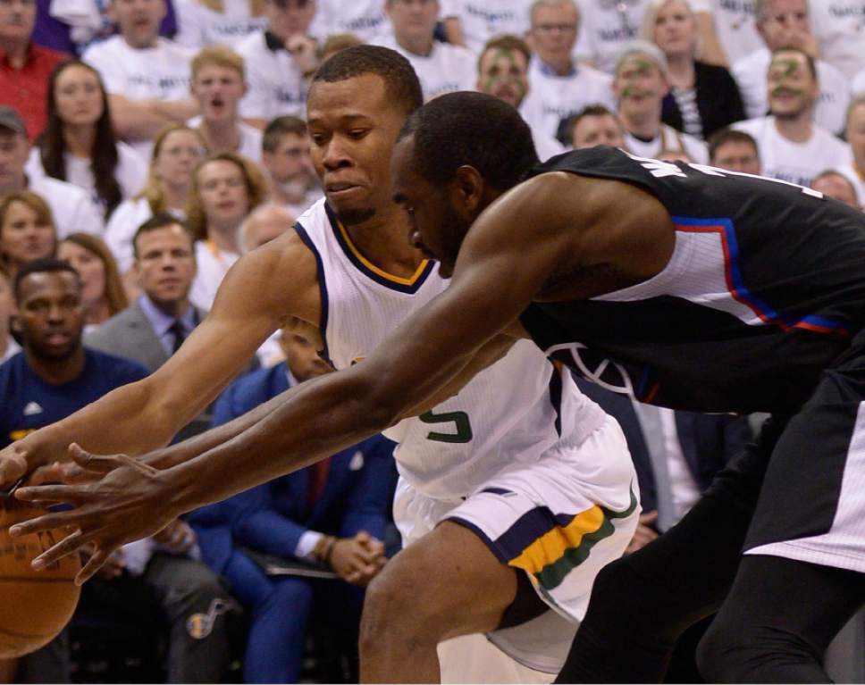 Leah Hogsten  |  The Salt Lake Tribune 
Utah Jazz guard Rodney Hood (5) and LA Clippers forward Luc Mbah a Moute (12) fight for a loose ball.  The Utah Jazz lead the Los Angeles Clippers after the third quarter during Game 3 of their first-round Western Conference playoff series at Vivint Smart Home Arena, Friday, April 21, 2017.