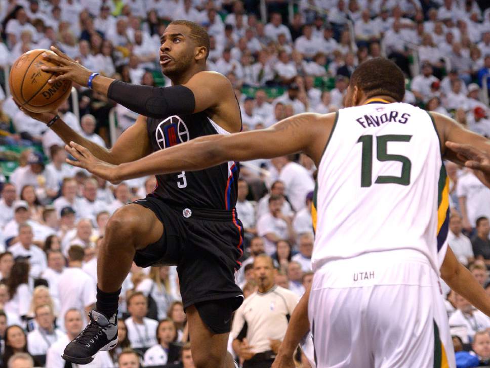 Leah Hogsten  |  The Salt Lake Tribune 
LA Clippers guard Chris Paul (3) drives to the net around Utah Jazz forward Derrick Favors (15). The Utah Jazz lead the Los Angeles Clippers after the third quarter during Game 3 of their first-round Western Conference playoff series at Vivint Smart Home Arena, Friday, April 21, 2017.