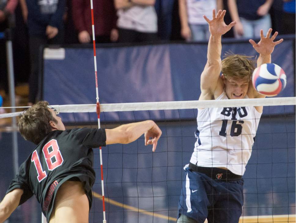 Rick Egan  |  The Salt Lake Tribune

Clay Jones (18) Stanford, hits the ball, as Tim Dobbert (16) BYU defends, in Volleyball action, BYU vs. Stanford, at the Smith Field House in Provo,  Saturday, April 15, 2017.