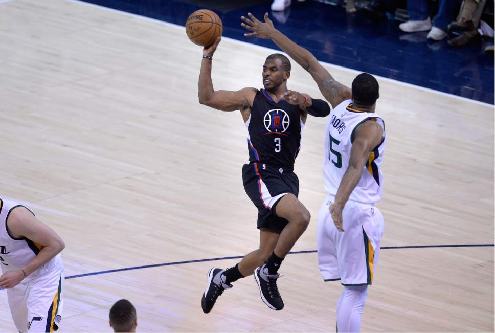 Scott Sommerdorf | The Salt Lake Tribune
LA Clippers guard Chris Paul (3) passes after driving against Utah Jazz forward Derrick Favors (15) during second half play. The Utah Jazz beat the LA Clipper 105-98 to take Game 4 and tie up the Western Conference playoff series at 2-2, Sunday, April 23, 2017.