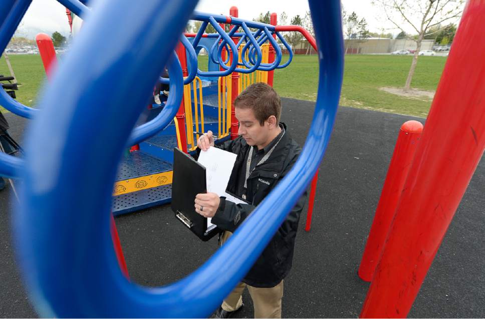 Francisco Kjolseth | The Salt Lake Tribune
Zach Torres-George, an environmental health scientist with the Salt Lake County Health Department performs a safety inspection of the playground at Woodrow Wilson Elementary in Salt Lake. Next week is National Playground Safety Week and the health department is looking to promote safe practices on the playgrounds.