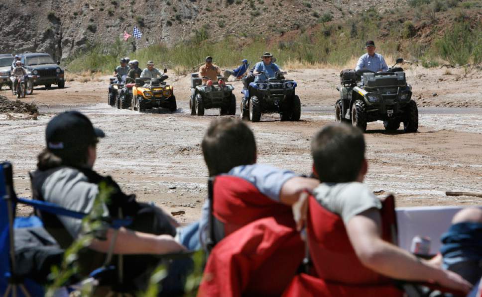 Scott Sommerdorf  |  The Salt Lake Tribune


ATV'ers drive along the Paria Riverbed as anti-protest protestors at the "Picnic With a Purpose" watch in the foreground. ATV and off-road vehicle riders numbering just over 100 protested BLM road closures in Grand Staircase-Escalante National Monument and will gather to force their way onto federal land. They will be criss-crossing the Paria River. Saturday, 5/9/09.