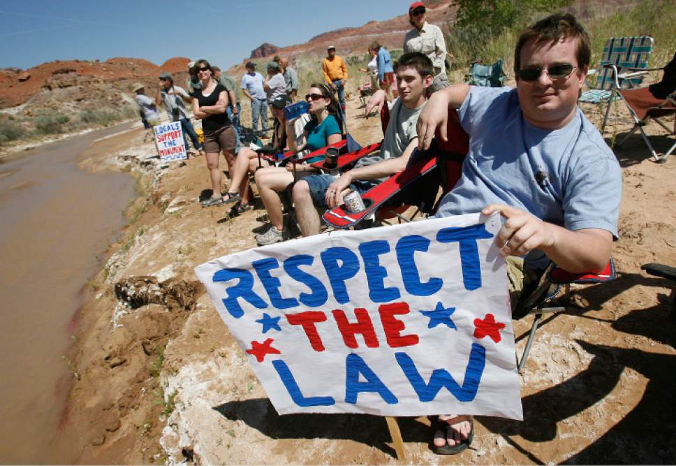 Scott Sommerdorf  |  The Salt Lake Tribune


At right, Justin Miller (of Salt Lake) and other anti-ATV protestors at the "Picnic with a Purpose" make their points to ATV'ers as they pass this spot on the Paria Riverbed. ATV and off-road vehicle riders numbering just over 100 protested BLM road closures in Grand Staircase-Escalante National Monument and will gather to force their way onto federal land. They will be criss-crossing the Paria River. Saturday, 5/9/09.