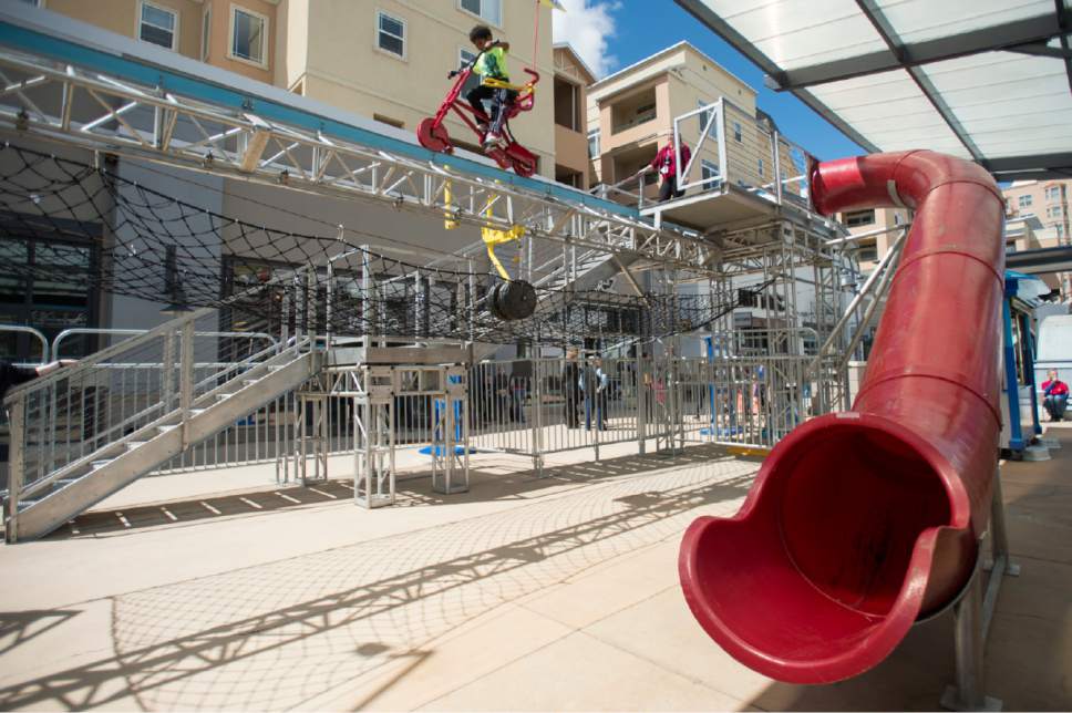 Rick Egan  |  The Salt Lake Tribune

Joshua Fairley, 7, Los Angeles, rides the SkyCycle, suspended 15 feet in the air, as Discovery Gateway Children's Museum unveiled a new outdoor exhibit. The SkyCycle exhibit will be located on the upper level of The Gateway center across from the museum, and will be open annually April through October."Friday, April 21, 2017.