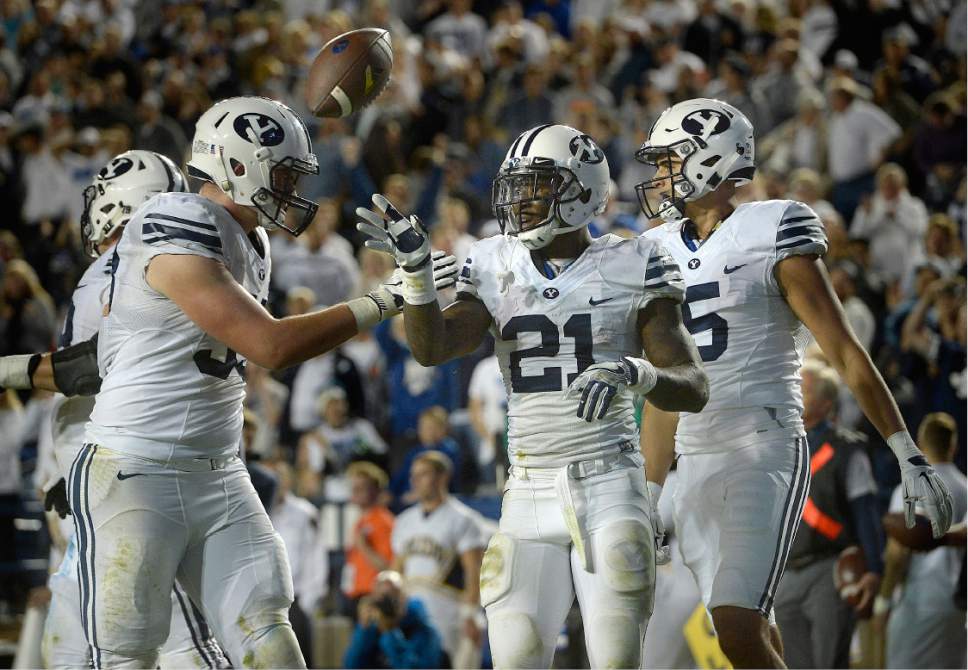 Scott Sommerdorf   |  The Salt Lake Tribune  
BYU RB Jamaal Williams (21) flips the ball away after a scoring run that was nullified by a holding penalty during second half play. Williams finished with 286 yards rushing and 5 TDs. TD runs as BYU defeated Toledo 55-53, Friday, September 30, 2016.