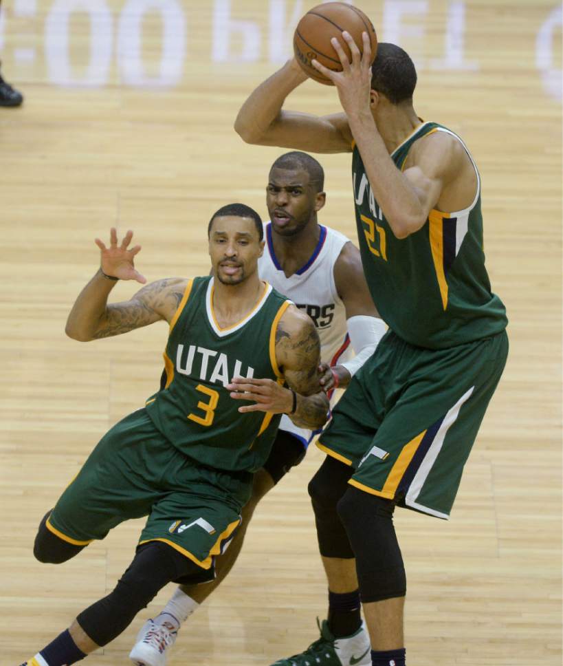 Steve Griffin  |  The Salt Lake Tribune


Utah Jazz center Rudy Gobert (27) holds the ball up as LA Clippers guard Chris Paul (3) chases Utah Jazz guard George Hill (3) during game 5 of the the Jazz versus Clippers NBA playoff game at the Staples Center in Los Angeles Tuesday April 25, 2017.