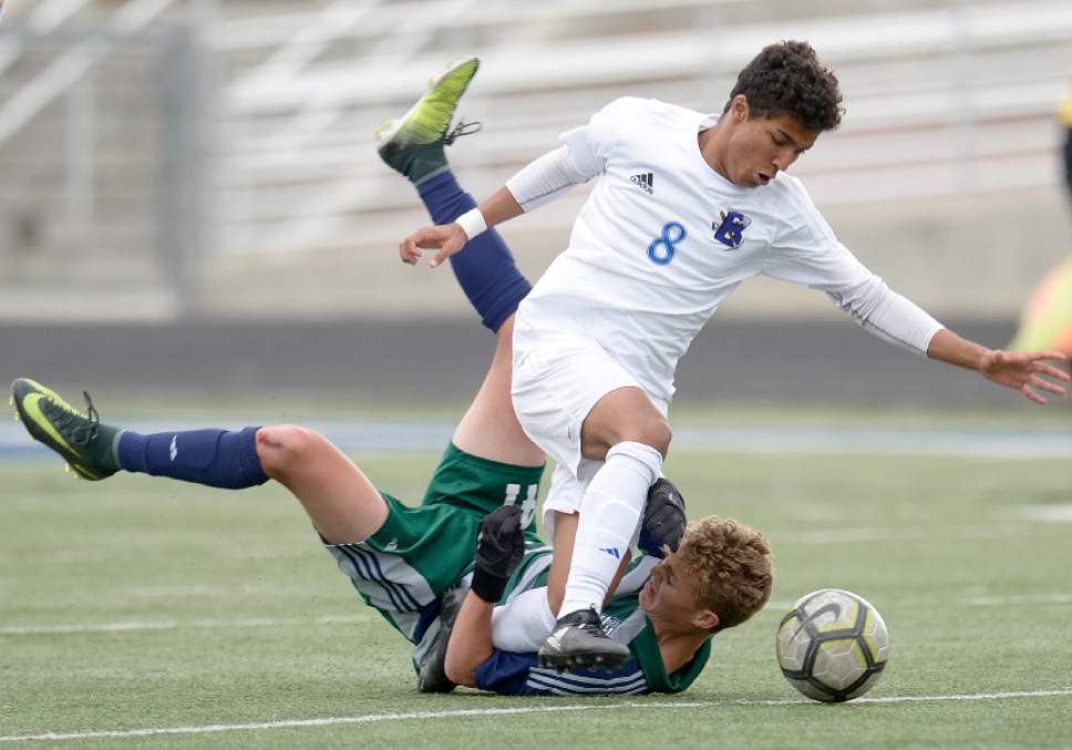 Leah Hogsten  |  The Salt Lake Tribune 
Bingham's Isaiah Cardoso flies over Copper Hills' Eli Nixon. Bingham High School boys' soccer team defeated Copper Hills High School 2-1, during their game April 25, 2017.