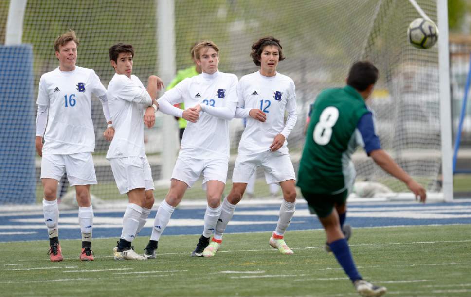 Leah Hogsten  |  The Salt Lake Tribune 
Copper Hills' Carlos Becerra-Gomez kicks a penalty kick to teammate  Aaron Nixon who knocks in a goal. Bingham High School boys' soccer team defeated Copper Hills High School 2-1, during their game April 25, 2017.