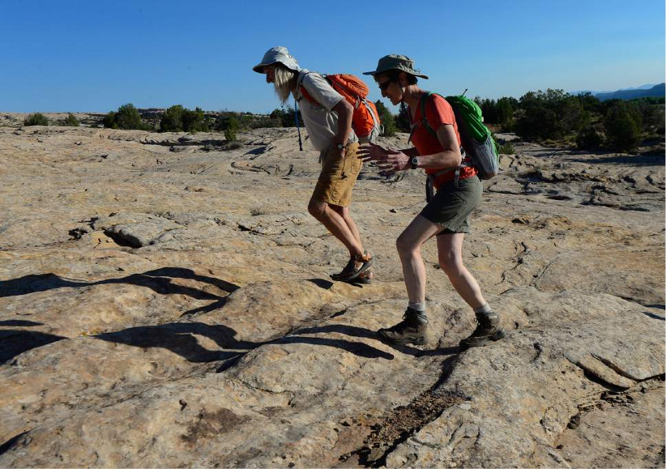 Scott Sommerdorf   |  The Salt Lake Tribune  
U.S. Interior Secretary Sally Jewell walks with Vaughn Hadenfeldt of Friends of Cedar Mesa, over the slickrock on the way to Butler Wash to view petroglyphs - some of which have been vandalized -  Saturday, July 15, 2016.