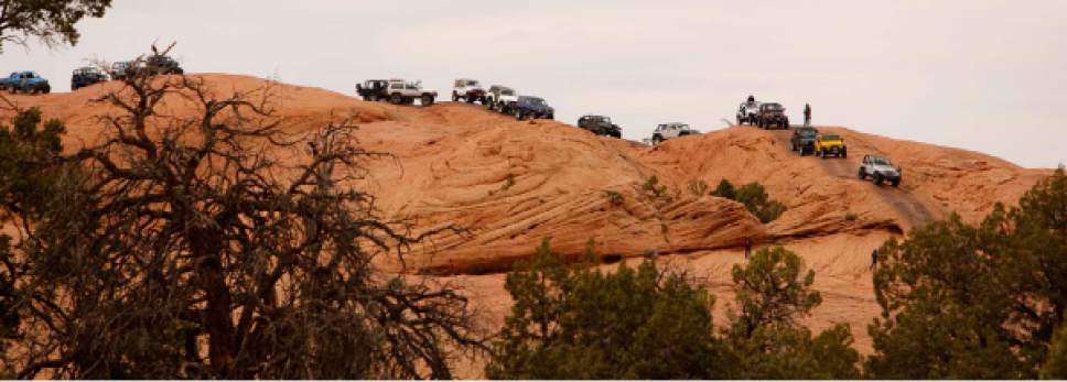 Trent Nelson  |  The Salt Lake Tribune

Jeeps back up on the Hell's Revenge 4x4 Trail, as thousands of Jeeps descended on the trails surrounding Moab for the annual Easter Jeep Safari, Friday April 10, 2009.