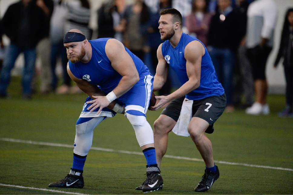 Francisco Kjolseth | The Salt Lake Tribune
Quarterback Taysom Hill gets the ball from offensive lineman Andrew Eide as they work out for BYU's Pro Day on Friday, March 24, 2017.