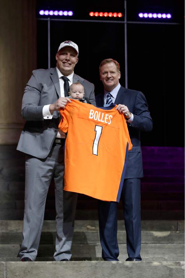 Utah's Garett Bolles, left, and son, Kingston, pose with NFL commissioner Roger Goodell after being selected by the Denver Broncos during the first round of the 2017 NFL football draft, Thursday, April 27, 2017, in Philadelphia. (AP Photo/Matt Rourke)