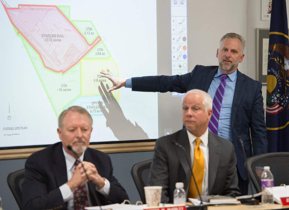 Leah Hogsten  |  The Salt Lake Tribune 
l-r UTA board chair Robert McKinley,  President and CEO Jerry Benson and Bret Millburn discuss the Clearfield land site. The Utah Transit Authority Board discussed  logistics of the controversial UTA Clearfield land deal during their open meeting, Wednesday, April 26, 2017.