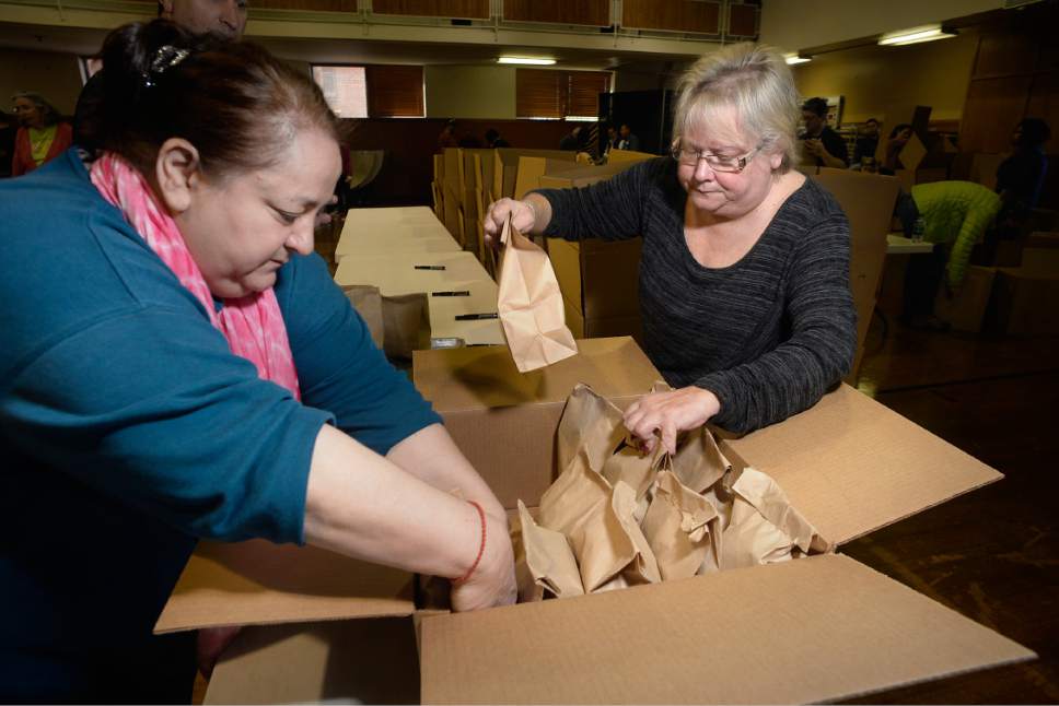 Scott Sommerdorf | The Salt Lake Tribune
Nitsa Tsouts, left, and Kathy Neofitos load finished lunches into boxes at the Greek Orthodox Church of Greater Salt Lake as they prepared 3,500 sack lunches for area homeless shelters at the Hellenic Memorial Building, Saturday, April 29, 2017.