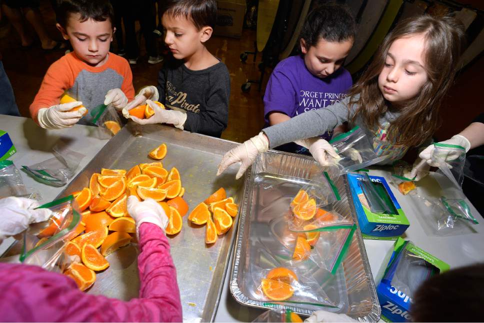 Scott Sommerdorf | The Salt Lake Tribune
Children of the Greek Orthodox Church of Greater Salt Lake prepared bags of orange slices - part of the 3,500 sack lunches made for area homeless shelters at the Hellenic Memorial Building, Saturday, April 29, 2017.