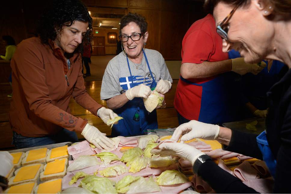 Scott Sommerdorf | The Salt Lake Tribune
Kathy McGrath, center, helps make ham and cheese sandwiches at the Greek Orthodox Church of Greater Salt Lake as the group prepared 3,500 sack lunches for area homeless shelters at the Hellenic Memorial Building, Saturday, April 29, 2017.