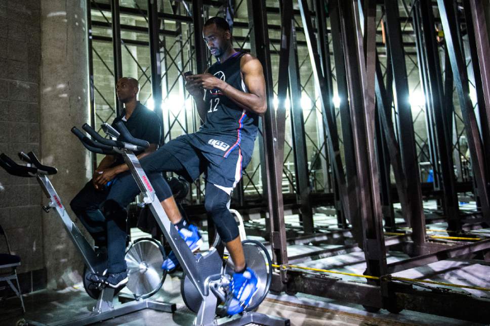 Chris Detrick  |  The Salt Lake Tribune
LA Clippers forward Luc Mbah a Moute (12) checks his phone while riding a stationary bike after the game at Vivint Smart Home Arena Friday, April 28, 2017.  LA Clippers defeated Utah Jazz 98-93.