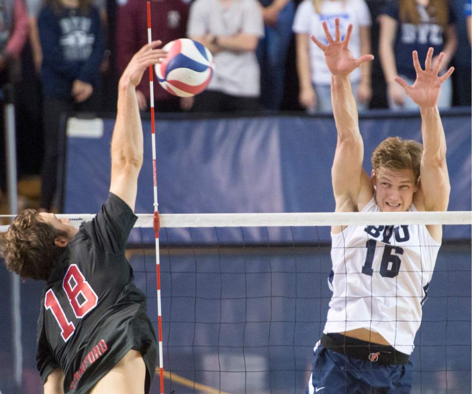 Rick Egan  |  The Salt Lake Tribune

Clay Jones (18) Stanford, hits the ball, as Tim Dobbert (16) BYU defends, in Volleyball action, BYU vs. Stanford, at the Smith Field House in Provo,  Saturday, April 15, 2017.