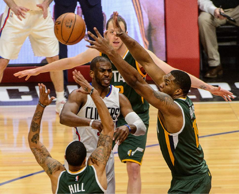 Trent Nelson  |  The Salt Lake Tribune
LA Clippers guard Chris Paul (3) passes through the arms of Utah Jazz guard George Hill (3) and Utah Jazz forward Derrick Favors (15) as the Utah Jazz face the Los Angeles Clippers in Game 7 at STAPLES Center in Los Angeles, California, Sunday April 30, 2017.
