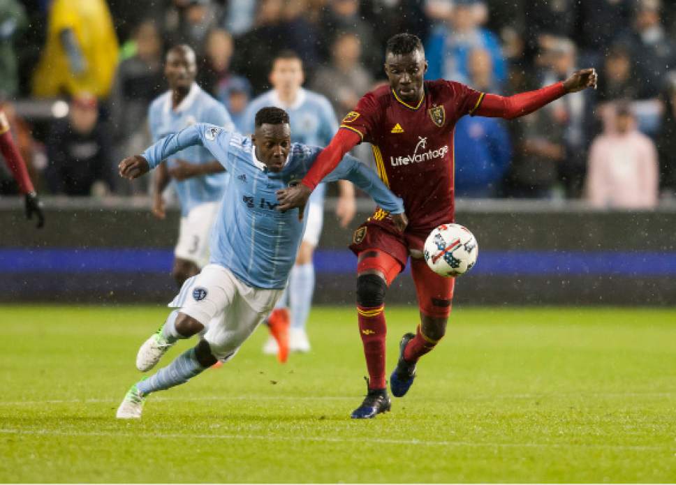 Real Salt Lake midfielder Sunday Stephens (8) and Sporting Kansas City forward Gerso fight for control of the ball during an MLS soccer match Saturday, April 29, 2017, in Kansas City, Kan. (Nick Tre. Smith/The Kansas City Star via AP)