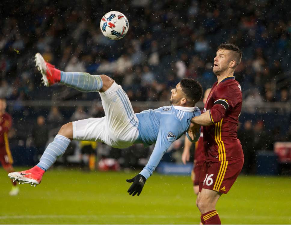 Sporting Kansas City forward Dom Dwyer (14) attempts a bicycle kick against Real Salt Lake defender (16) Chris Wingert during the first half of an MLS soccer match Saturday, April 29,, 2017, in Kansas City, Kan. (Nick Tre. Smith/The Kansas City Star via AP)