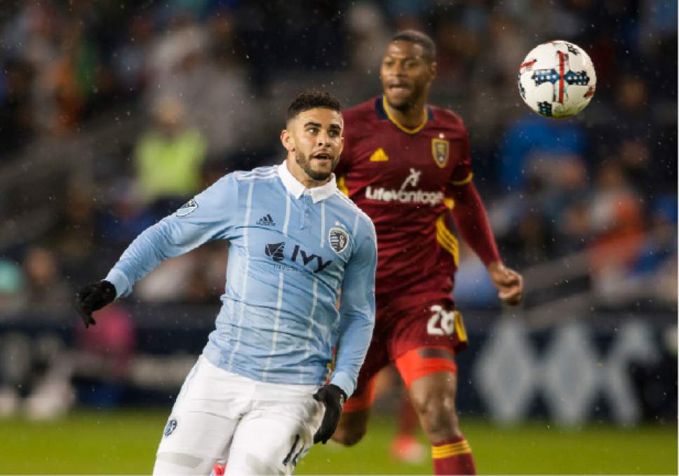 Sporting Kansas City forward Dom Dwyer (14) chases down the ball in front of Real Salt Lake's Chris Shuler during the first half of an MLS soccer match Saturday, April 29, 2017, in Kansas City, Kan. (Nick Tre. Smith/The Kansas City Star via AP)