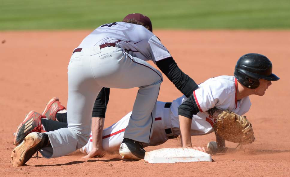 Francisco Kjolseth | The Salt Lake Tribune
American Fork's Brayden Howard gets tangled up in the glove of Eli Norman of Lone Peak after sliding safely back to first base during game action at American Fork on Tuesday, May 2, 2017.