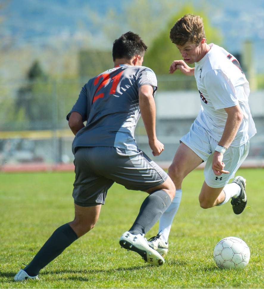 Chris Detrick  |  The Salt Lake Tribune
Skyridge's Tyler Rollins (21) and Alta's Nick Lowrimore (15) during the game at Alta High School Tuesday, May 2, 2017.