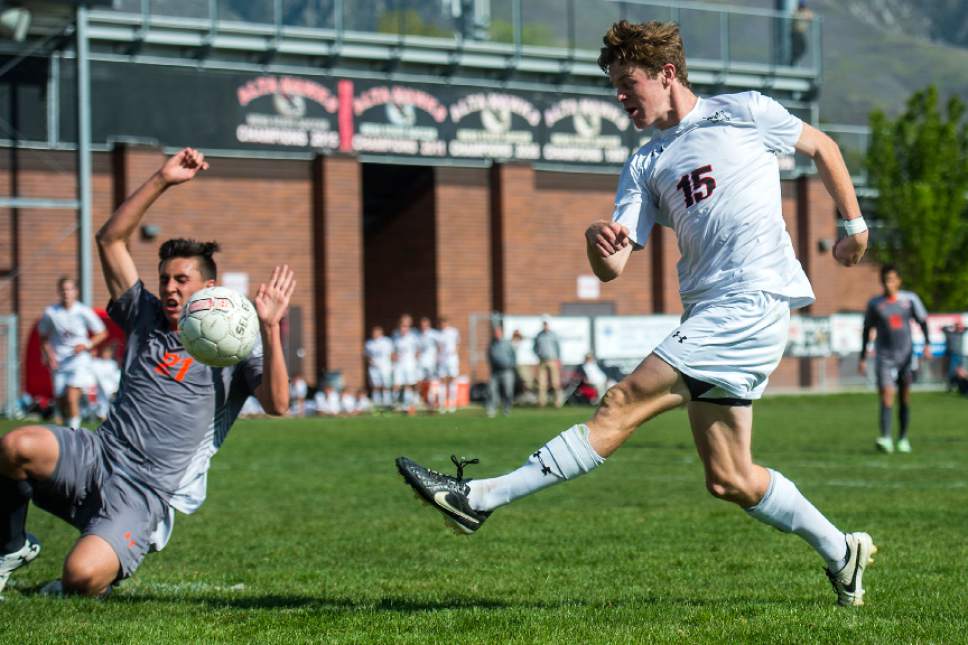 Chris Detrick  |  The Salt Lake Tribune
Alta's Nick Lowrimore (15) kicks the ball past Skyridge's Tyler Rollins (21) during the game at Alta High School Tuesday, May 2, 2017.