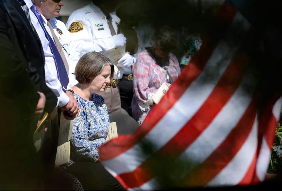 Scott Sommerdorf | The Salt Lake Tribune
Erika Barney, widow of Officer Doug Barney listens as Sergeant Jeff Evans reads the list of fallen officers during the Salt Lake County Sheriff's Office's annual memorial service hosted by the Salt Lake County Sheriff's Office Mutual Aid Association, Wednesday, May 3, 2017.