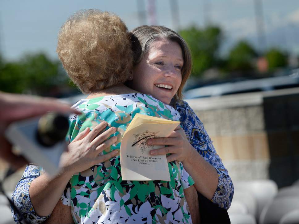 Scott Sommerdorf  |  The Salt Lake Tribune
Erika Barney, widow of Officer Doug Barney, hugs a friend Wednesday at the end of the Salt Lake County Sheriff's Office's annual memorial service hosted by the Salt Lake County Sheriff's Office Mutual Aid Association.