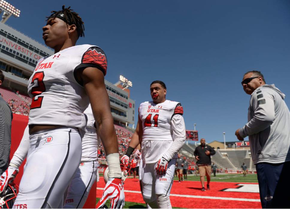 Leah Hogsten  |  The Salt Lake Tribune 
Defensive back Philip Afia and defensive end Hauati Pututau leave the field at halftime. The University of Utah Utes were back in action  during the 16th-annual Red-White football game on Saturday, April 15, 2017 at  Rice-Eccles Stadium.
