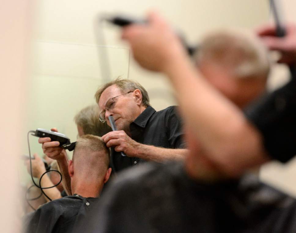 Steve Griffin  |  The Salt Lake Tribune
Stuart Stone cuts a man's hair at the Weigland Center in Salt Lake City Monday April 17, 2017. Stone as been volunteering his services giving haircuts to homeless individuals for some 20 years.