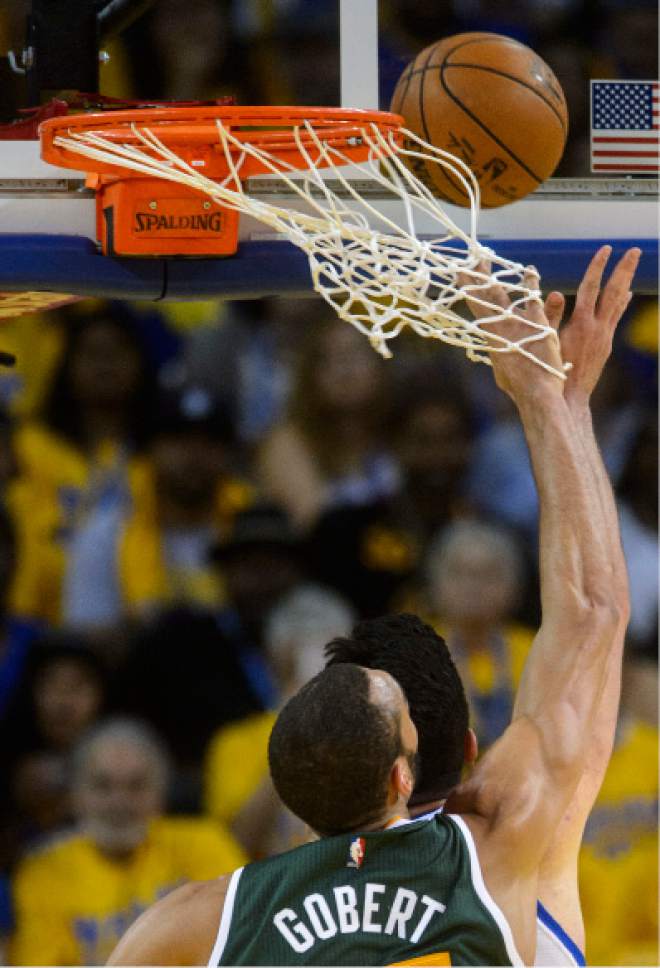 Steve Griffin  |  The Salt Lake Tribune


Utah Jazz center Rudy Gobert (27) gets his hand caught in the net as he blocks the shot of Golden State Warriors center Zaza Pachulia (27) during NBA playoff game between the Utah Jazz and the Golden State Warriors at Oracle Arena in Oakland Tuesday May 2, 2017.