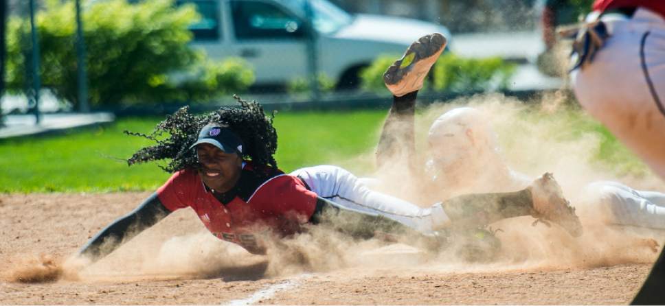 Chris Detrick  |  The Salt Lake Tribune
Davis' Paige Reynolds (1) slides safely into third past West's Jazmyn Rollin (4) during the game at West High School Wednesday, May 3, 2017.  Davis defeated West game 3-1.