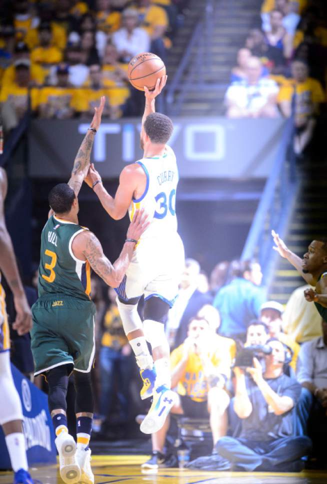 Steve Griffin  |  The Salt Lake Tribune


Golden State Warriors guard Stephen Curry (30) shoots over Utah Jazz guard George Hill (3) as a strobe light illuminates him during NBA playoff game between the Utah Jazz and the Golden State Warriors at Oracle Arena in Oakland Tuesday May 2, 2017.
