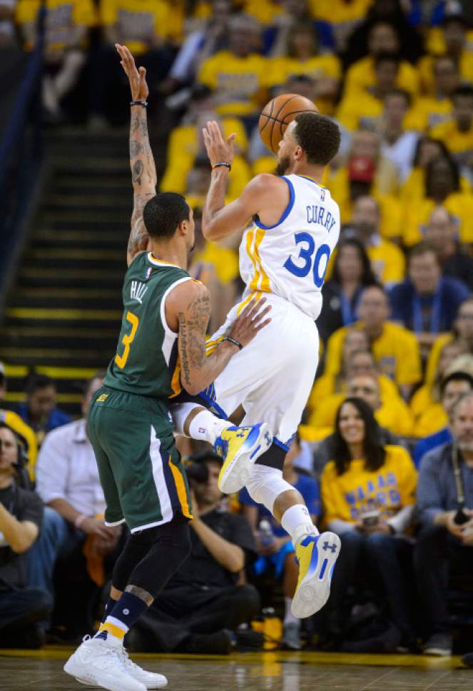 Steve Griffin  |  The Salt Lake Tribune


Golden State Warriors guard Stephen Curry (30) shoots on off balance shot over Utah Jazz guard George Hill (3) during NBA playoff game between the Utah Jazz and the Golden State Warriors at Oracle Arena in Oakland Tuesday May 2, 2017.