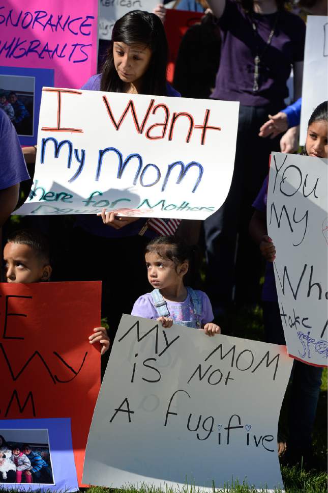 Francisco Kjolseth | The Salt Lake Tribune
Ariana Juarez, 2, center, who's mother was detained by ICE agents and taken to an undisclosed location last week, stands in silence during a rally by Mormon Women for Ethical Government and other concerned citizens who gathered at the Department of Homeland Security field office in West Valley City on Wed. May 3, 2017, in a show of solidarity for the young mother,  Silvia Avelar-Flores, who was arrested.
