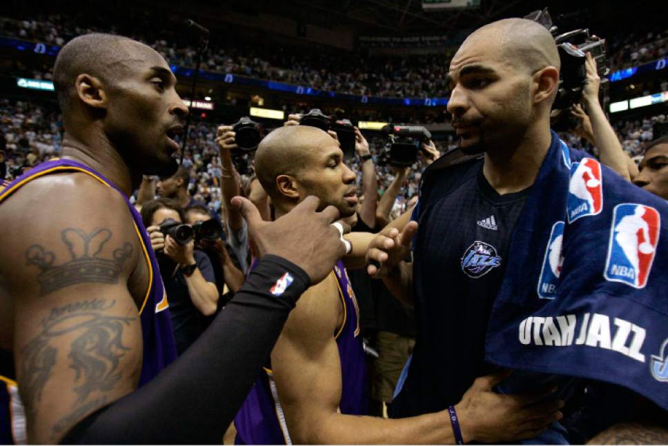 Trent Nelson  |  The Salt Lake Tribune

Utah Jazz forward Carlos Boozer (5, right) embraces Los Angeles Lakers guard Derek Fisher (2) after the Jazz loss in game 6 of the Western Conference semi-finals at Energy Solutions Arena Friday, May 16, 2008. Los Angeles Lakers guard Kobe Bryant  (24) at left.