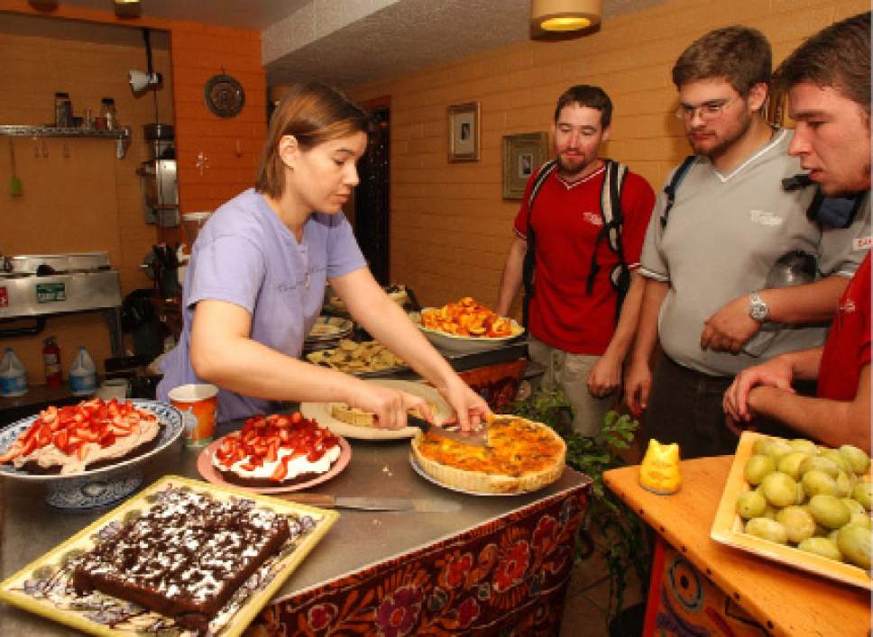 Rick Egan  |  The Salt Lake Tribune

Denise Cerreta  dishes up some of her organic food for  Trevor Hurley, Nathan Kraft,  Eddie Schneider and Zachary Goick, some of her patrons, from the College of Massage Therapy, at the One World Cafe on Sept. 4, 2003.